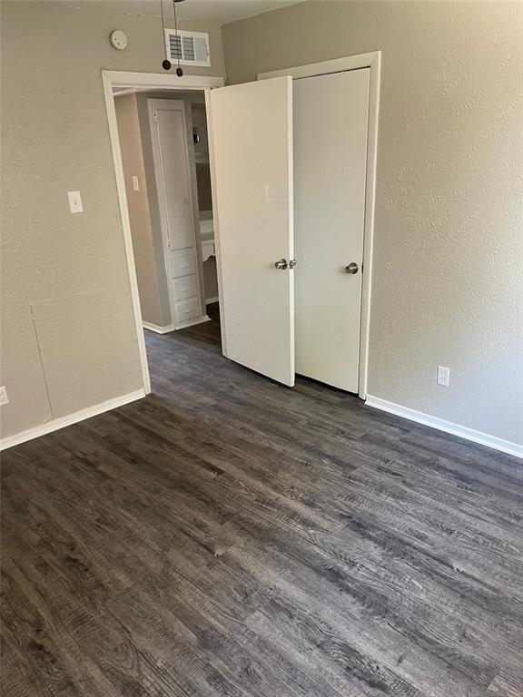 5526 Reiger Avenue, Unit 109 Dallas, TX 75214 - Photo 9 of 13 a view of an empty room with wooden floor and a ceiling fan
