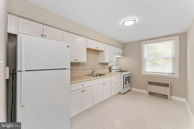 a kitchen with cabinets and appliances