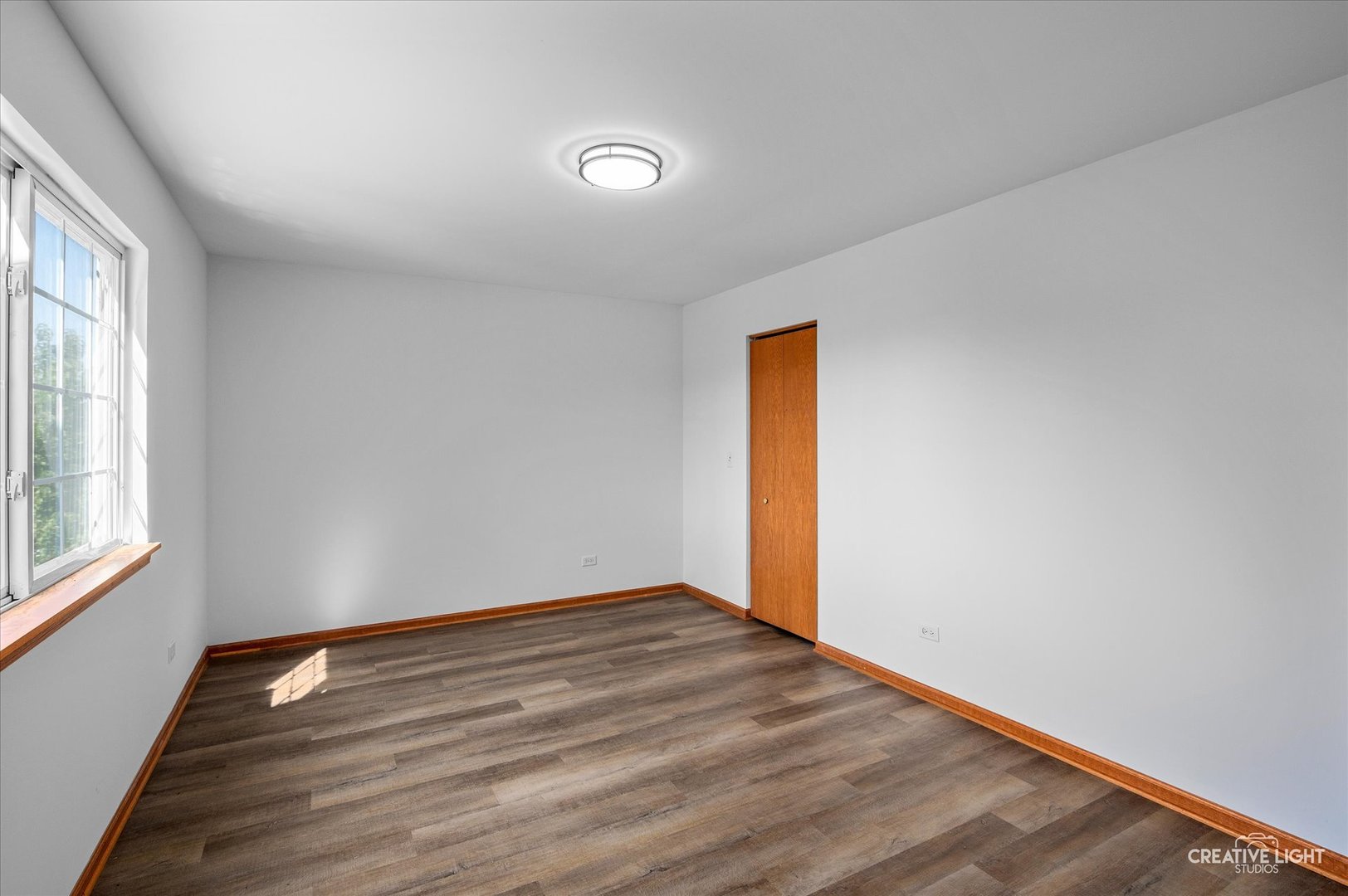 1603 Valley Ridge Drive Plainfield, IL 60586 - Photo 16 of 27 an empty room with wooden floor and windows