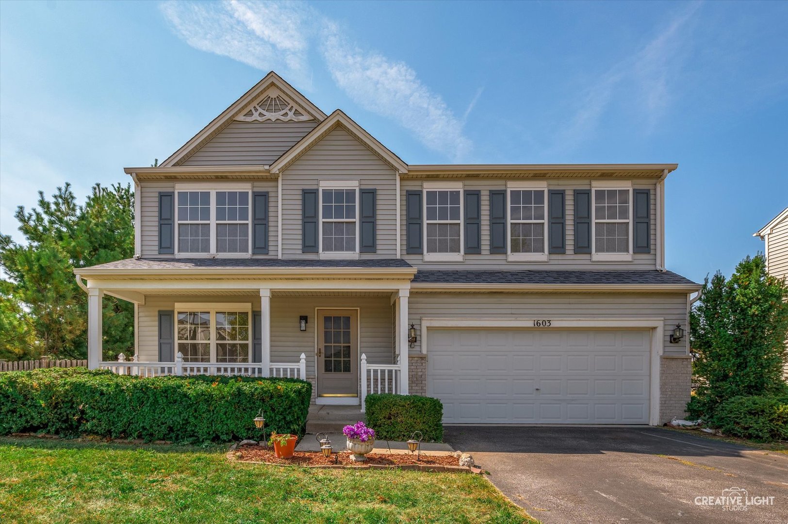 1603 Valley Ridge Drive Plainfield, IL 60586 - Photo 2 of 27 a front view of a house with a yard and garage