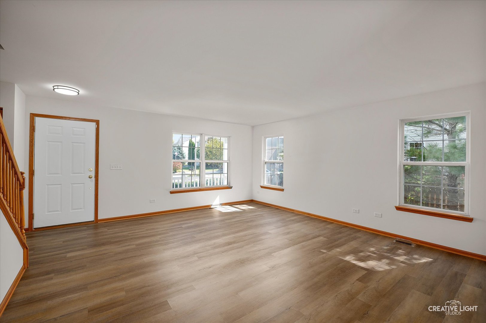 1603 Valley Ridge Drive Plainfield, IL 60586 - Photo 5 of 27 a view of an empty room with wooden floor and a window