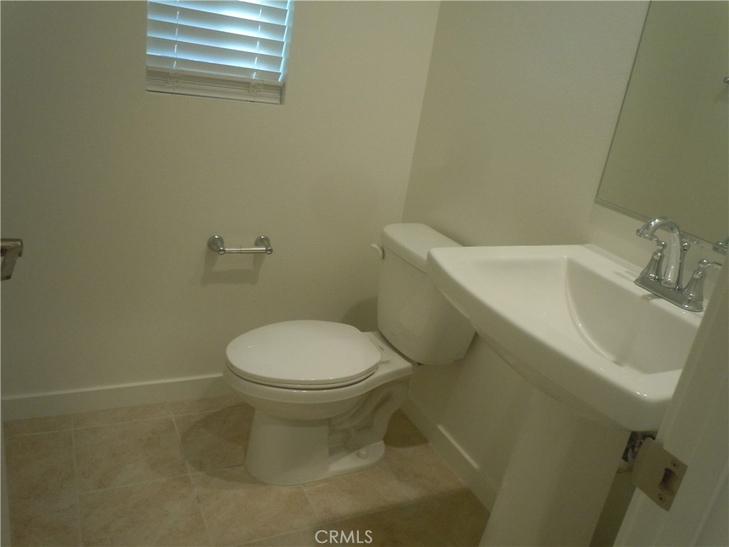 32402 Brunello Way Temecula, CA 92591 - Photo 13 of 22 a white toilet sitting next to a white sink
