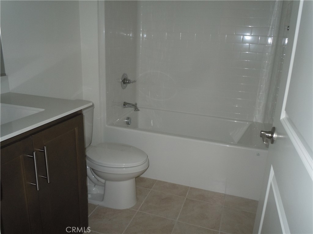 32402 Brunello Way Temecula, CA 92591 - Photo 17 of 22 a bathroom with a toilet sink and bathtub