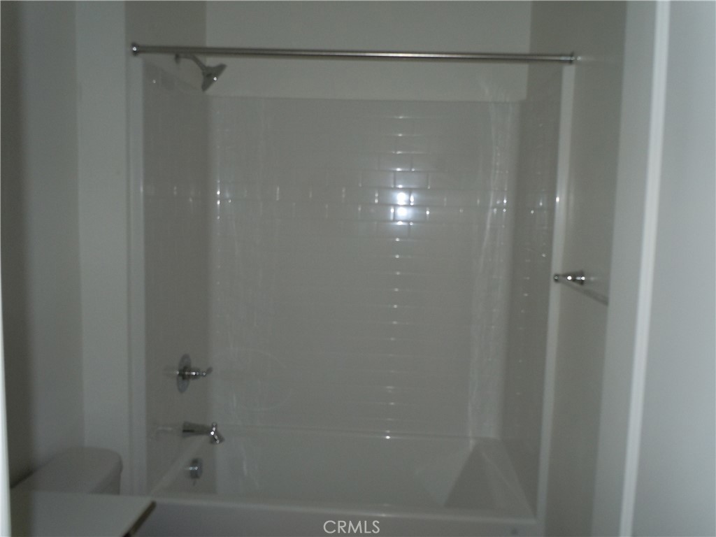 32402 Brunello Way Temecula, CA 92591 - Photo 18 of 22 a bathroom with a glass shower door