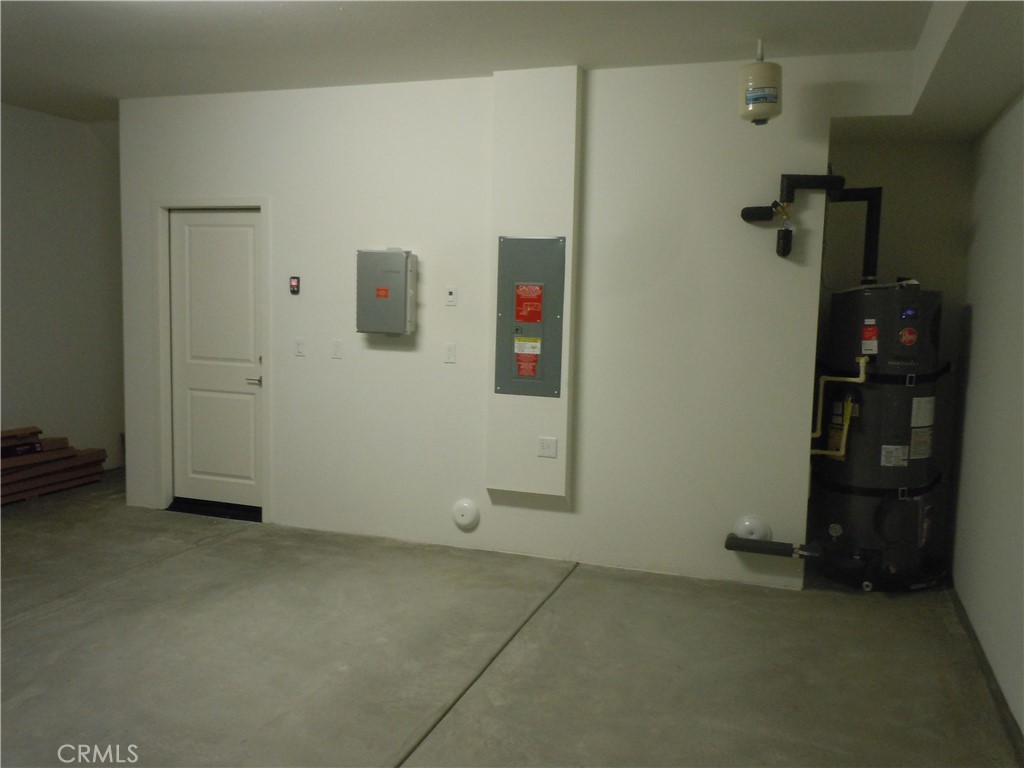32402 Brunello Way Temecula, CA 92591 - Photo 7 of 22 an empty room with water heater and storage