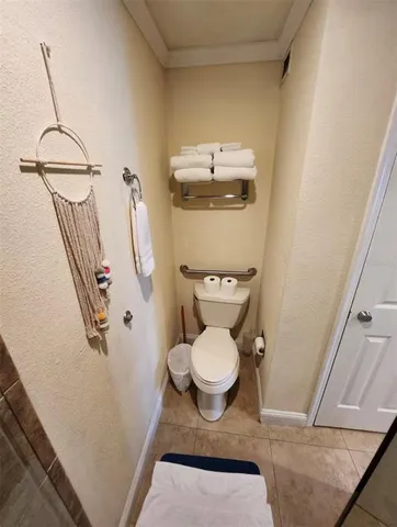 a bathroom with a toilet and a mirror