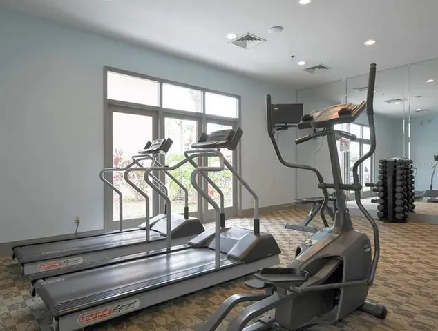 a room with gym equipment and windows