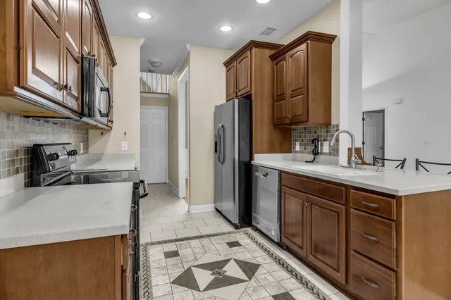a kitchen with a sink appliances and cabinets