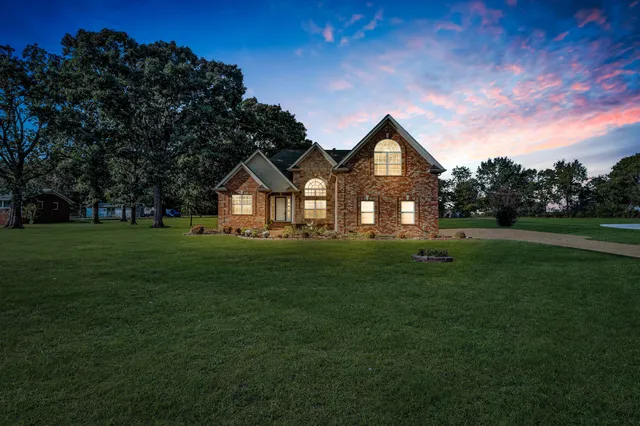 a front view of a house with a yard