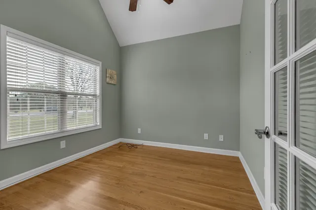 a view of a room with a wooden floor and a window