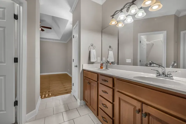 a spacious bathroom with a double vanity sink and a mirror