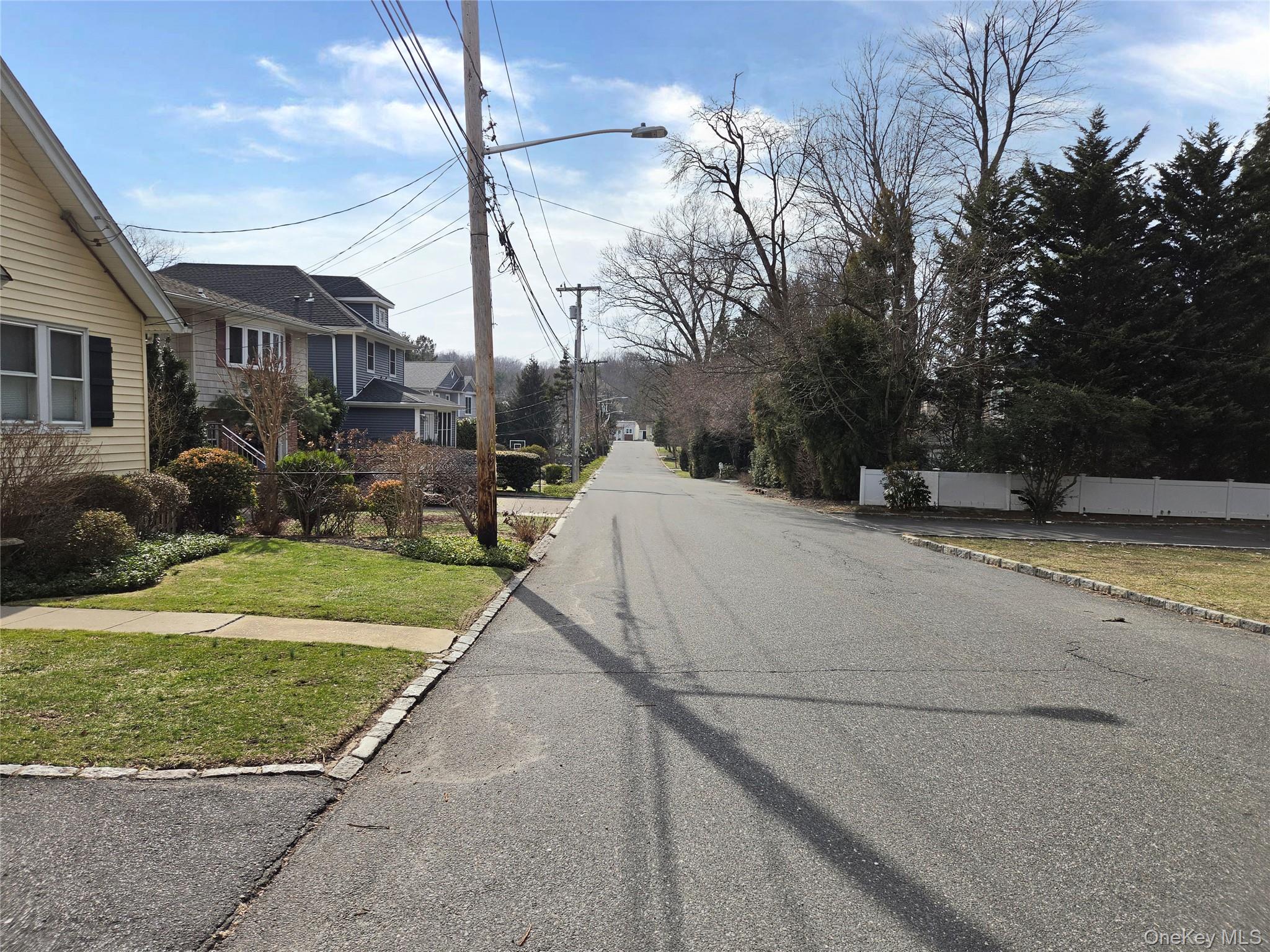 54 Cocks Lane Locust Valley, NY 11560 - Photo 6 of 6 a view of a white house with a yard and sitting area