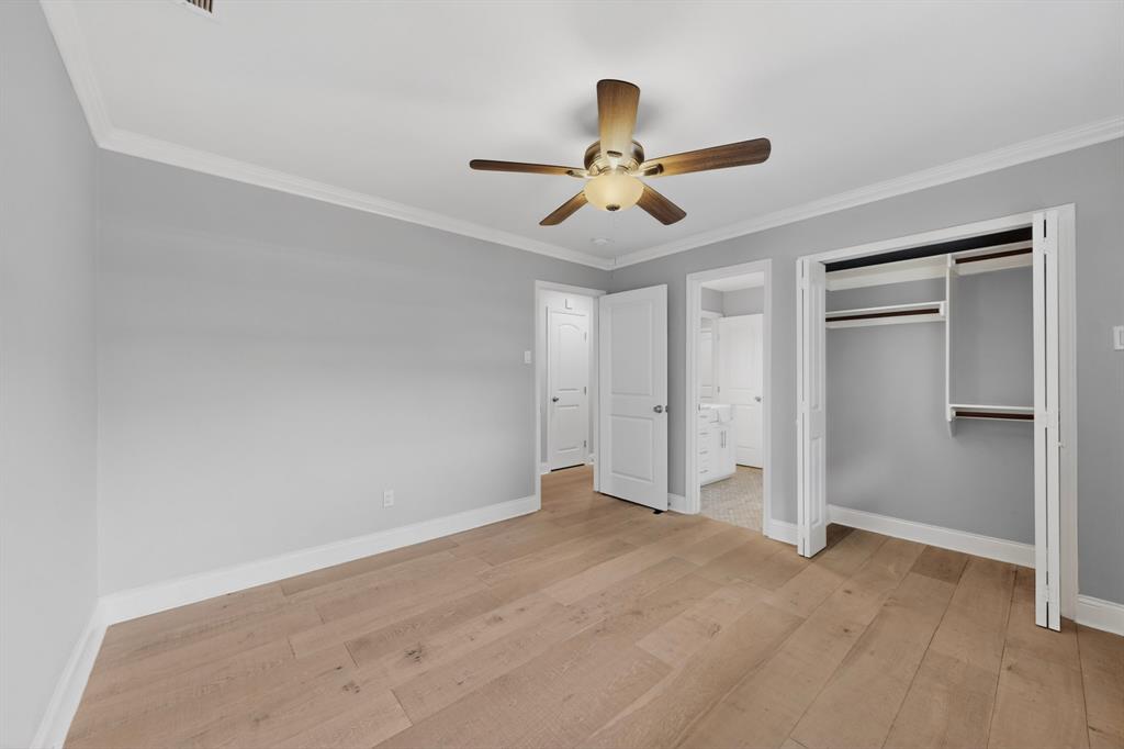 7631 Meadow Road Dallas, TX 75230 - Photo 21 of 40 A bright bedroom with a ceiling fan and a closet