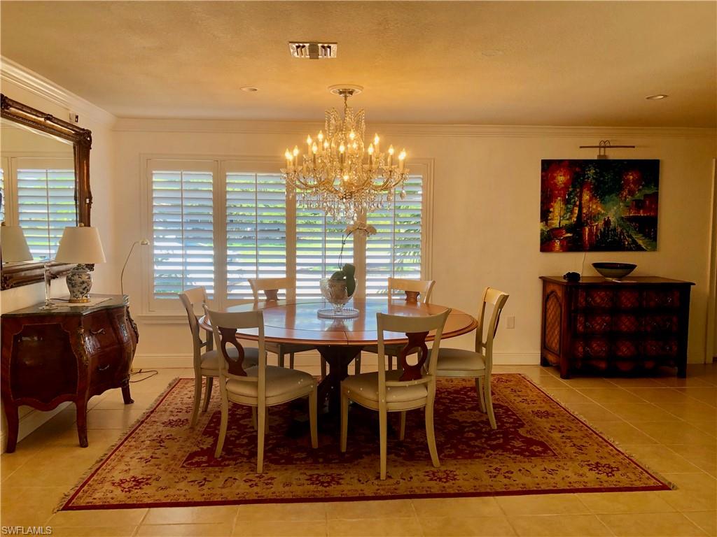 283 Cypress Way West Naples, FL 34110 - Photo 12 of 18 Bedroom with light tile patterned floors and a textured wall