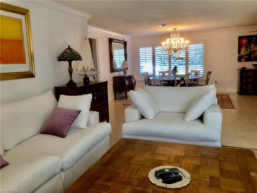 283 Cypress Way West Naples, FL 34110 - Photo 13 of 18 Kitchen featuring backsplash, white cabinets, dark stone countertops, and light tile patterned floors