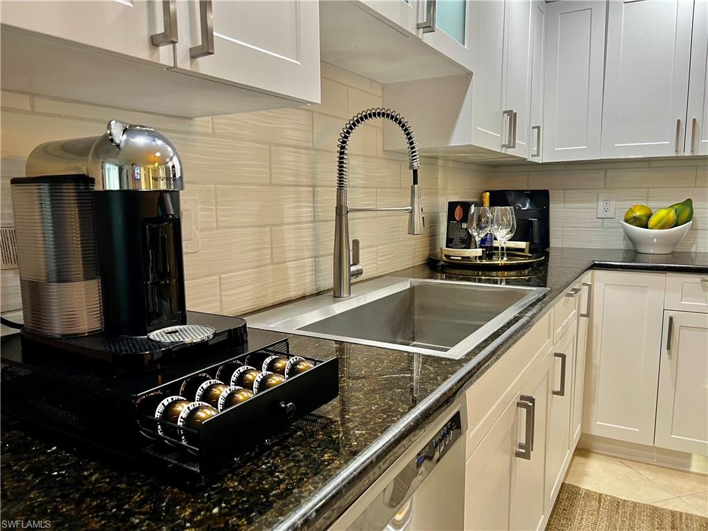 283 Cypress Way West Naples, FL 34110 - Photo 16 of 18 View of front of home with a garage, decorative driveway, and stucco siding