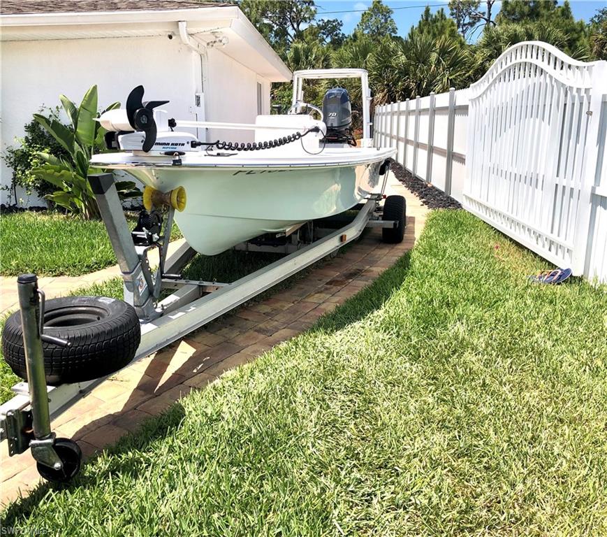 283 Cypress Way West Naples, FL 34110 - Photo 17 of 18 View of front of home featuring decorative driveway, an attached garage, and stucco siding