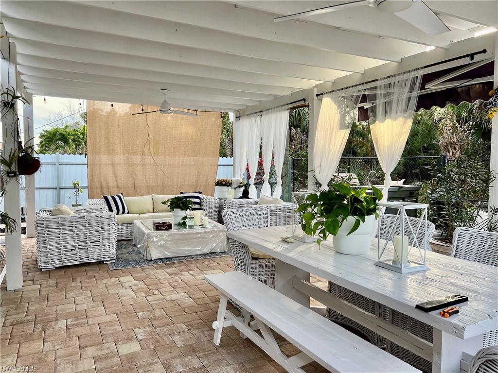 283 Cypress Way West Naples, FL 34110 - Photo 2 of 18 View of patio featuring outdoor dining area, an outdoor living space, and a ceiling fan