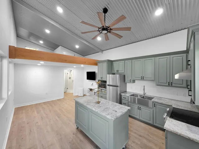 a kitchen with a sink cabinets and window