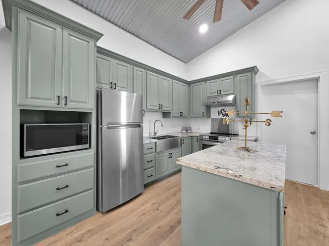 a kitchen with a refrigerator and a sink