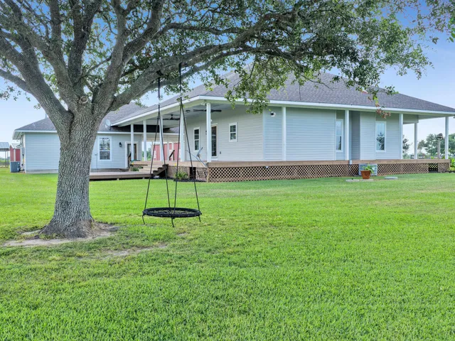 a house view with a sitting space and a garden