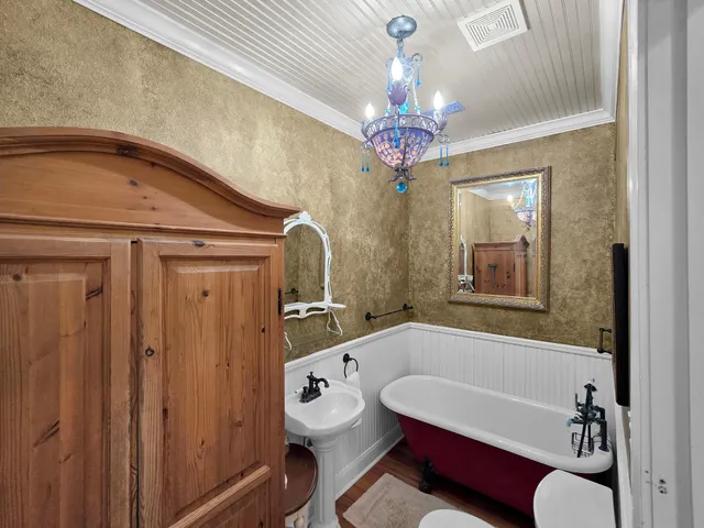 a bathroom with a tub sink and mirror
