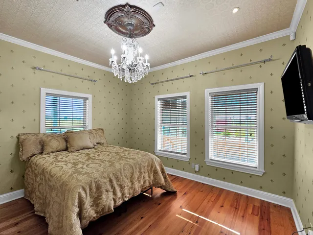 a bedroom with a large bed and a tv