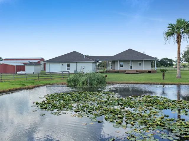 a front view of a house with a garden and yard
