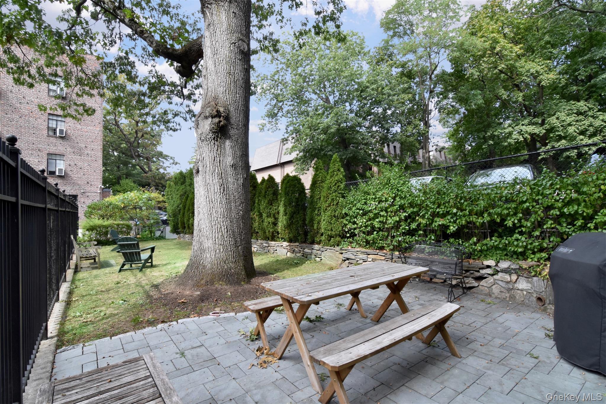 48 Sagamore Road, Unit 23 Bronxville, NY 10708 - Photo 22 of 23 a backyard of a house with outdoor seating