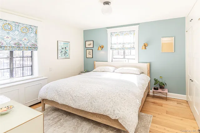 a large bed sitting in a bedroom next to a window