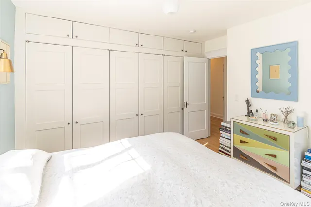 a bedroom with a bed and a mirror