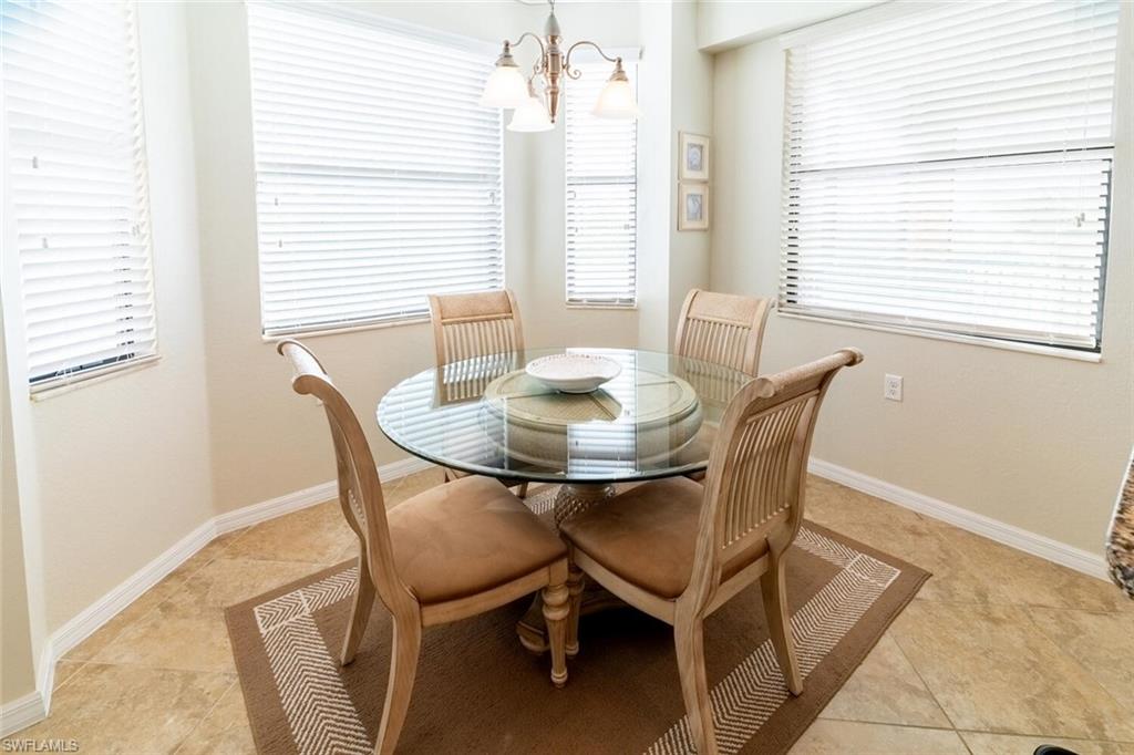 9731 Acqua Court, Unit 536 Naples, FL 34113 - Photo 12 of 48 a dining room with furniture and window