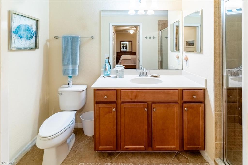 9731 Acqua Court, Unit 536 Naples, FL 34113 - Photo 18 of 48 a bathroom with a sink a toilet and mirror