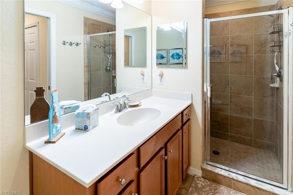 9731 Acqua Court, Unit 536 Naples, FL 34113 - Photo 19 of 48 a bathroom with a sink shower and a mirror