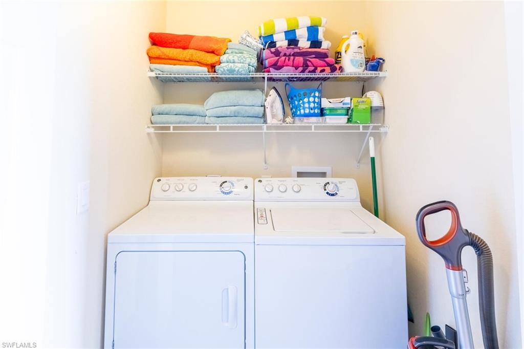 9731 Acqua Court, Unit 536 Naples, FL 34113 - Photo 24 of 48 a utility room with dryer and washer