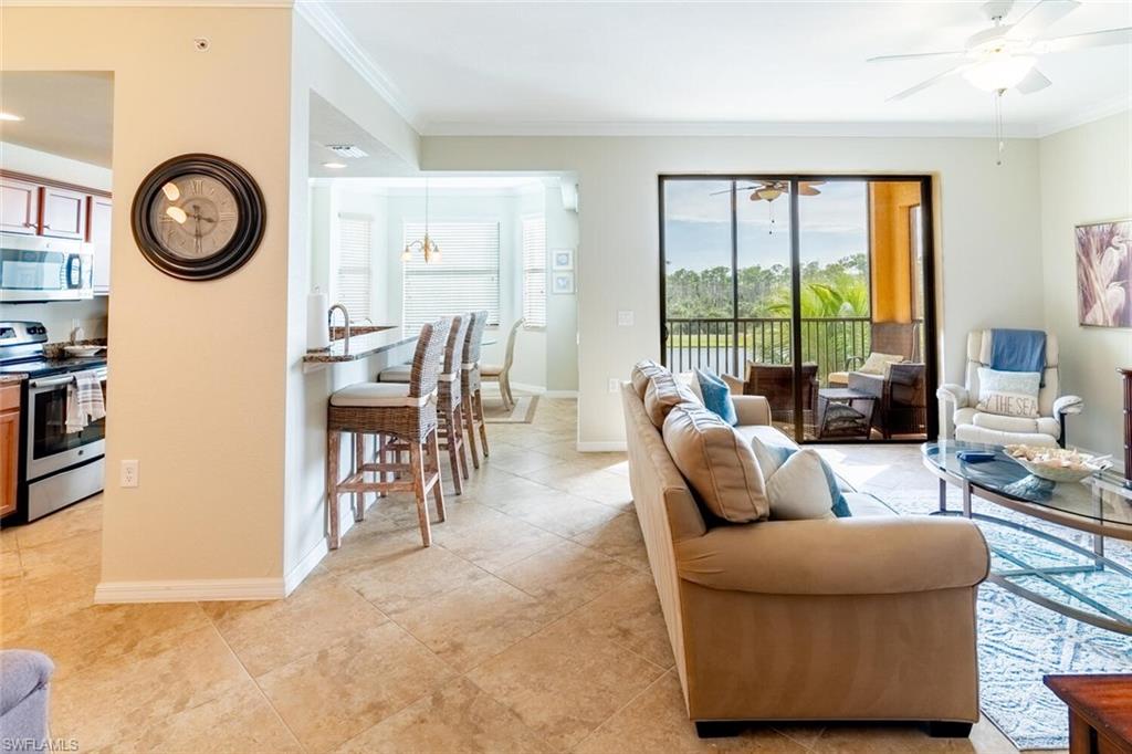 9731 Acqua Court, Unit 536 Naples, FL 34113 - Photo 5 of 48 a living room with furniture and a large window