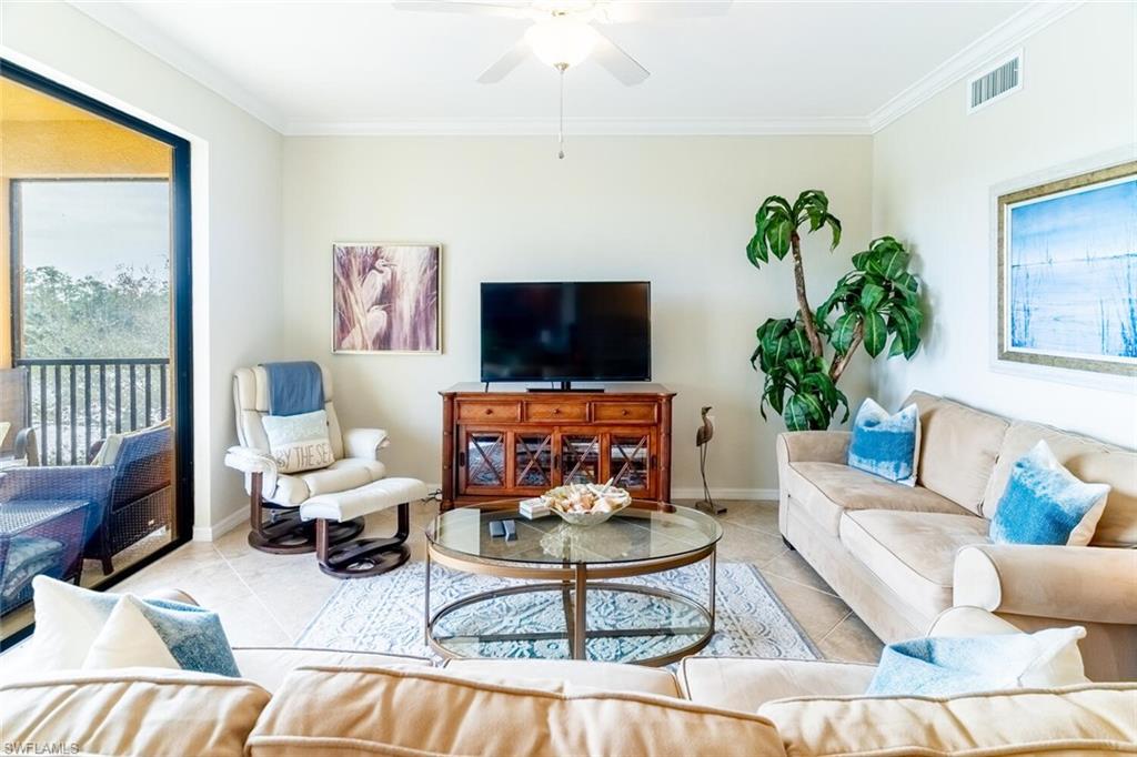 9731 Acqua Court, Unit 536 Naples, FL 34113 - Photo 8 of 48 a living room with furniture and a flat screen tv
