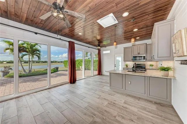 a large white kitchen with a refrigerator a stove top oven a sink and dishwasher