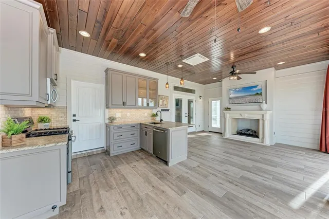 a kitchen with stainless steel appliances granite countertop a sink and cabinets
