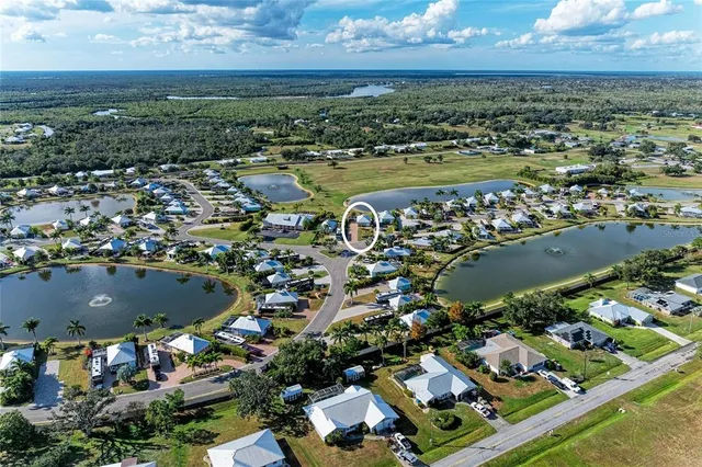 an aerial view of residential building and lake