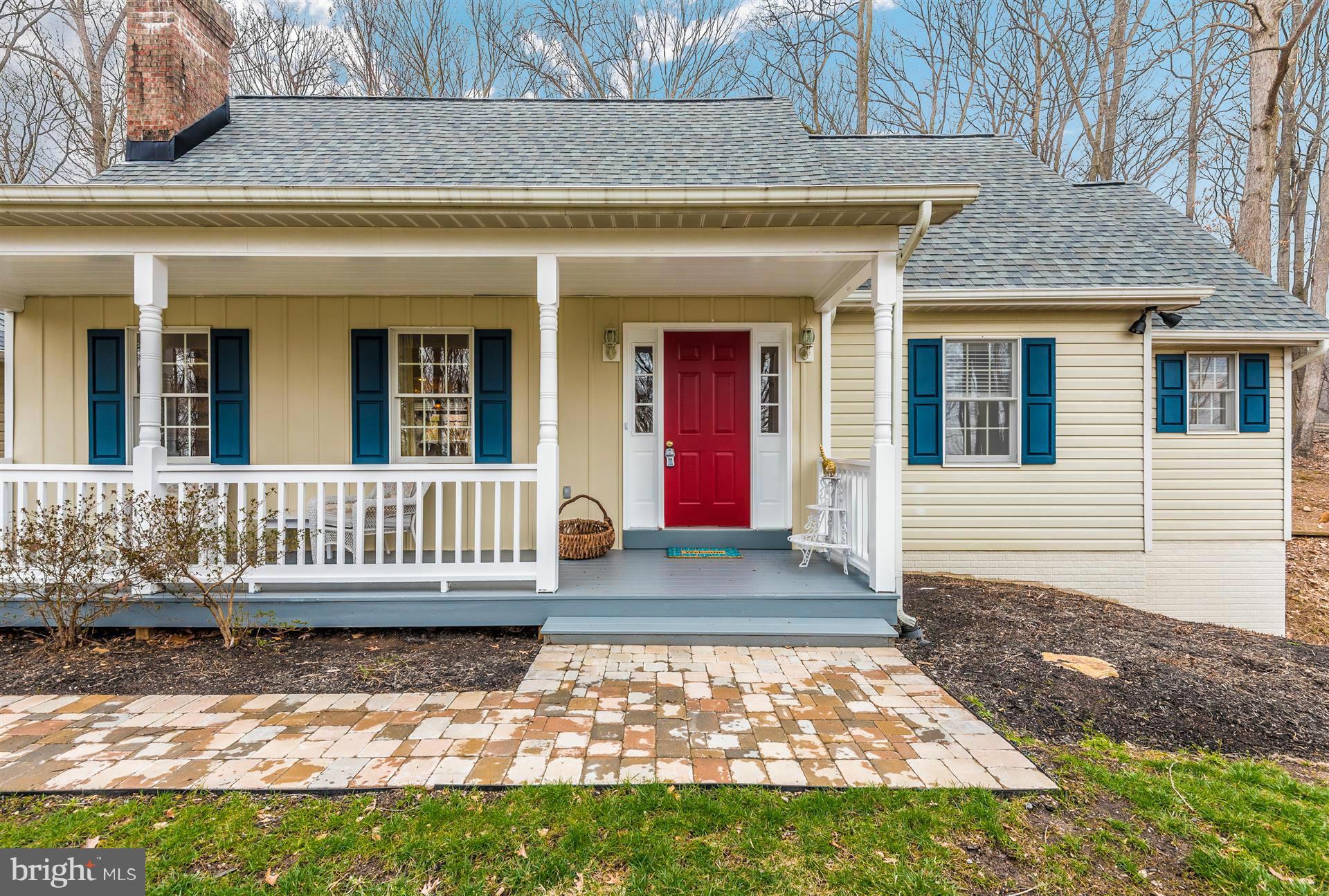 a view of a house with a small yard and wooden floor and fence