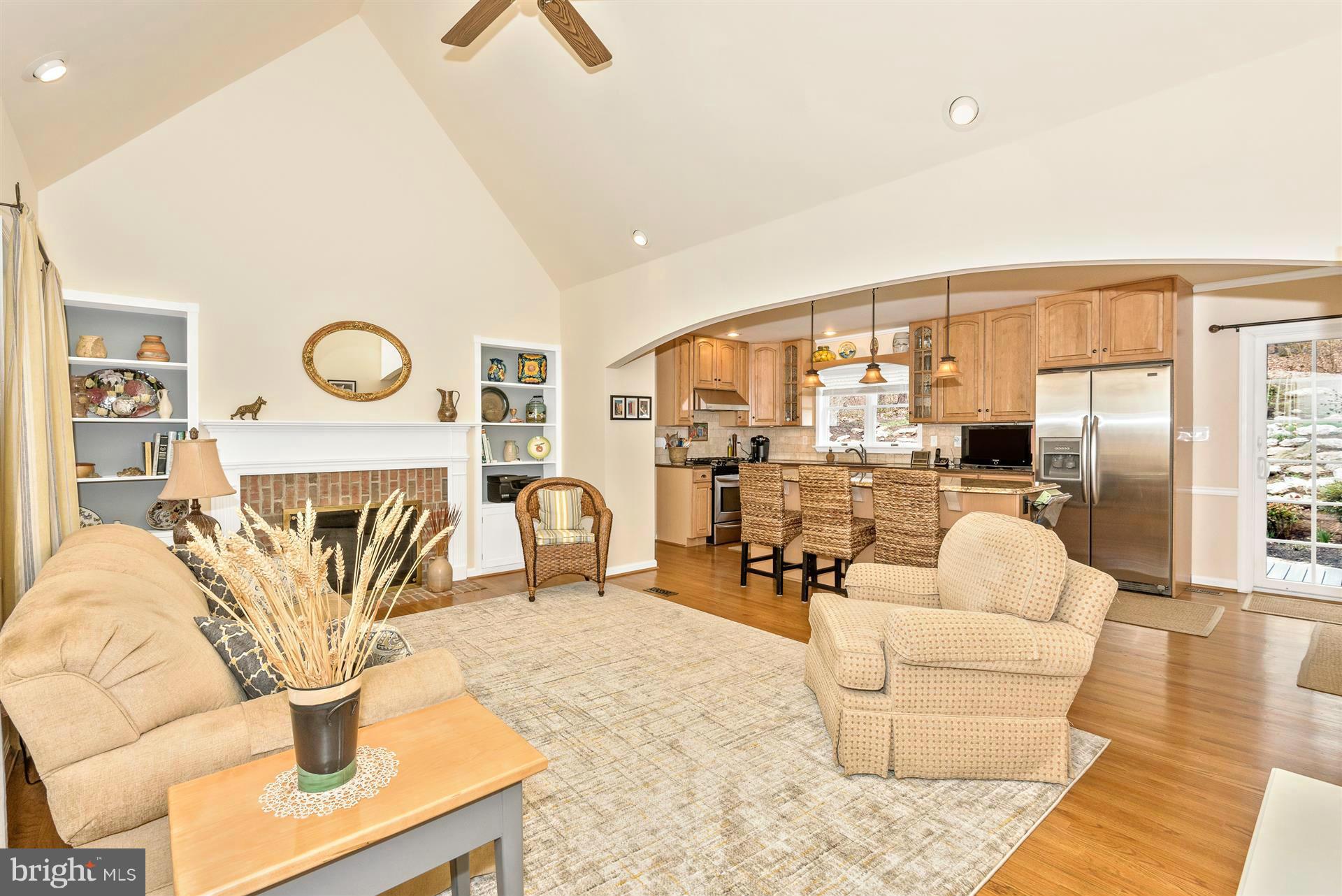 4230 Basford Road Frederick, MD 21703 - Photo 14 of 30 a living room with furniture a fireplace and a flat screen tv