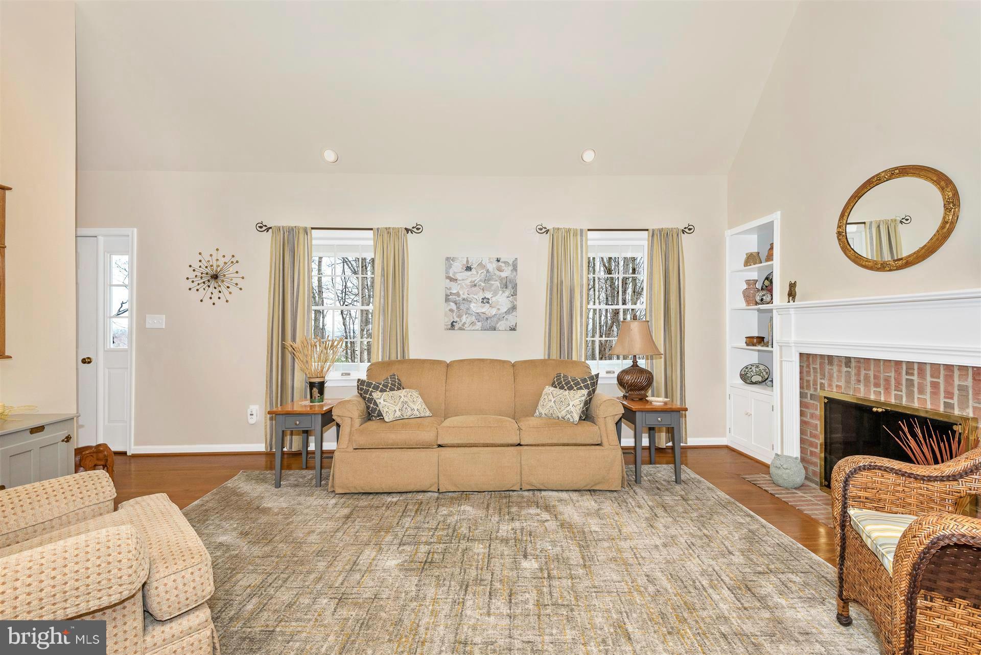 4230 Basford Road Frederick, MD 21703 - Photo 15 of 30 a living room with furniture a fireplace and a large window
