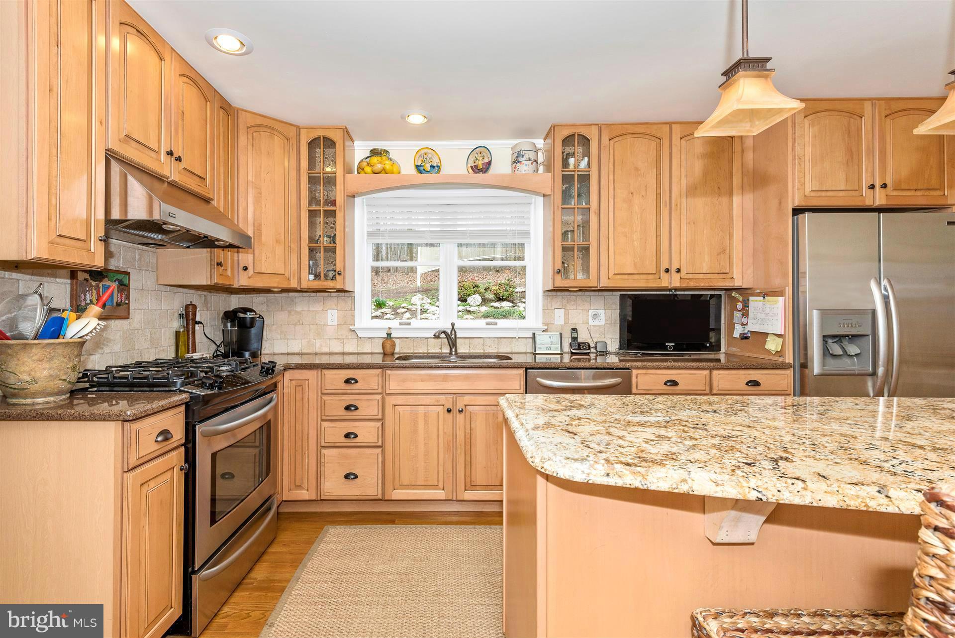 4230 Basford Road Frederick, MD 21703 - Photo 18 of 30 a kitchen with stainless steel appliances granite countertop a stove a sink and a microwave
