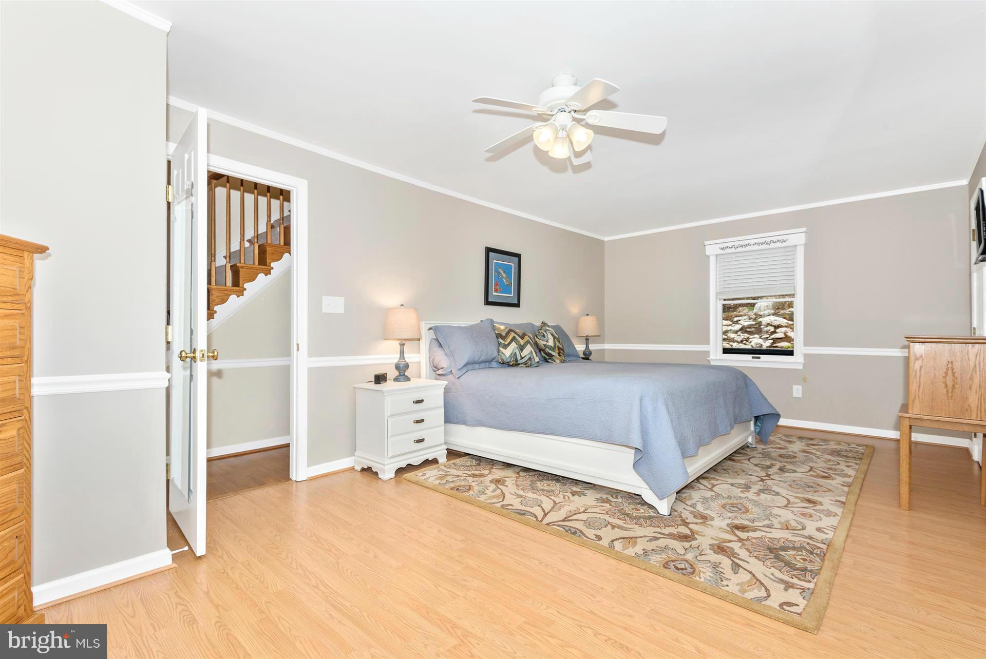 4230 Basford Road Frederick, MD 21703 - Photo 22 of 30 a bedroom with a large bed and a chandelier