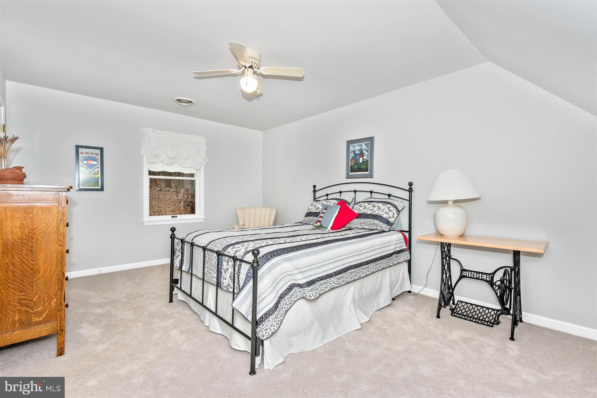 4230 Basford Road Frederick, MD 21703 - Photo 27 of 30 a bedroom with a bed and a chandelier