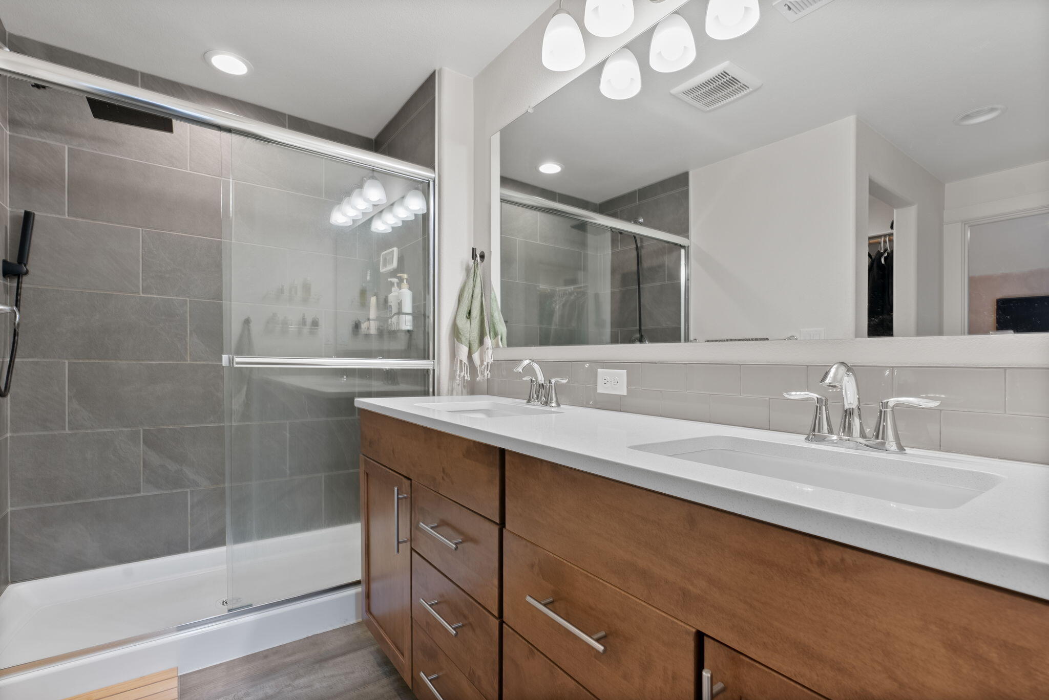 632 North Reed Street Sisters, OR 97759 - Photo 15 of 36 a bathroom with a double vanity sink mirror and shower