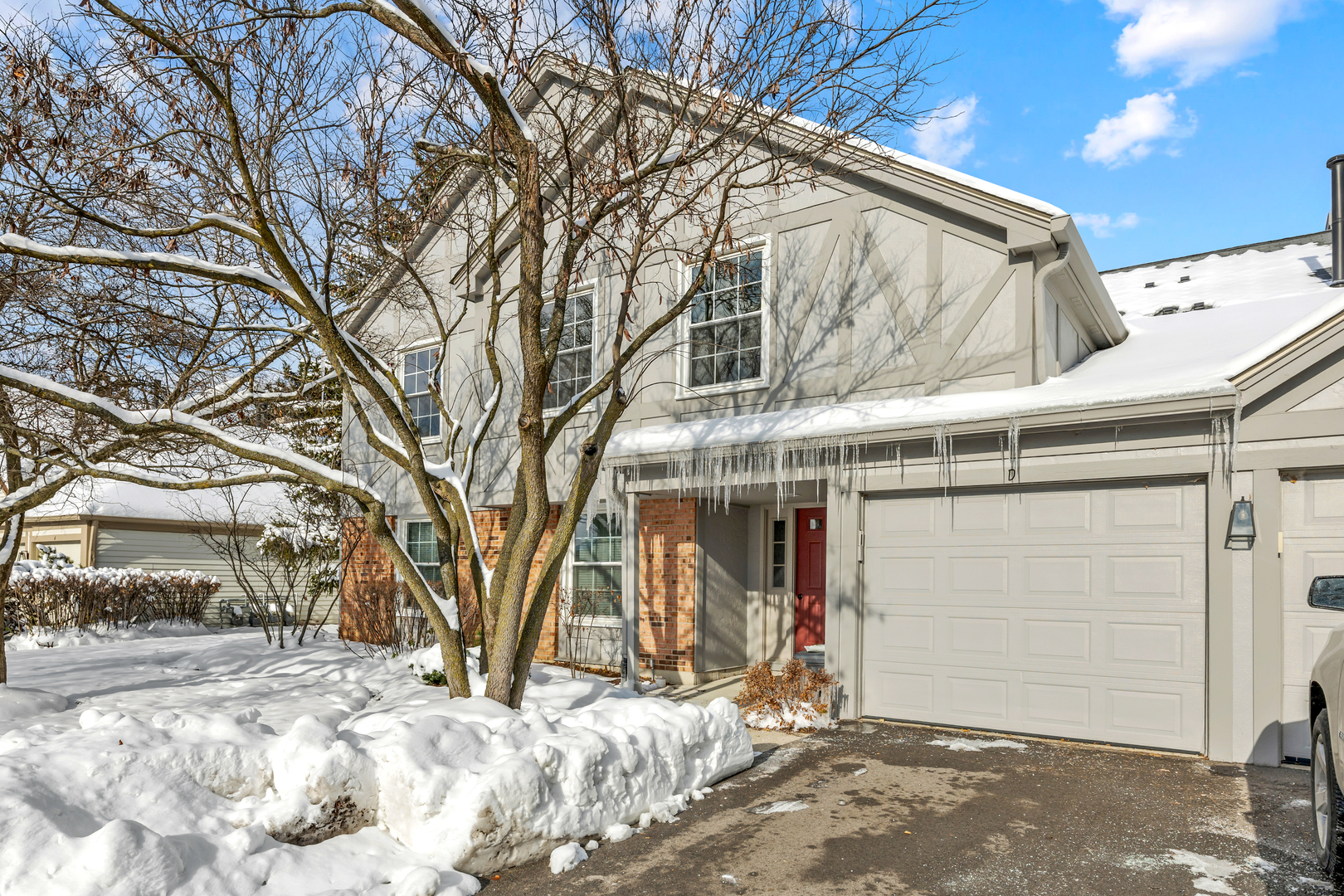 1907 Gresham Circle, Unit D Wheaton, IL 60189 - Photo 1 of 26 a view of a house with a snow in the yard