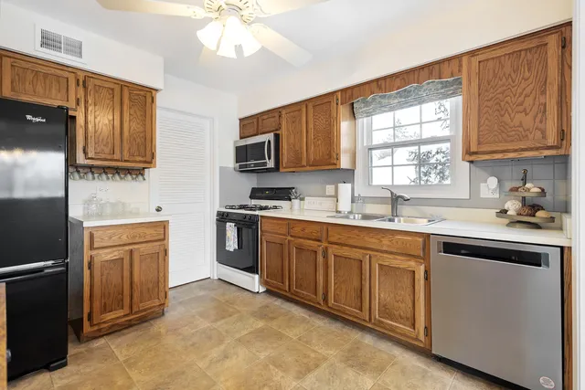 a kitchen with a sink stove and microwave