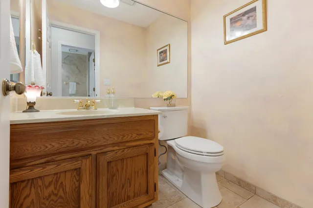a bathroom with a sink toilet and a mirror